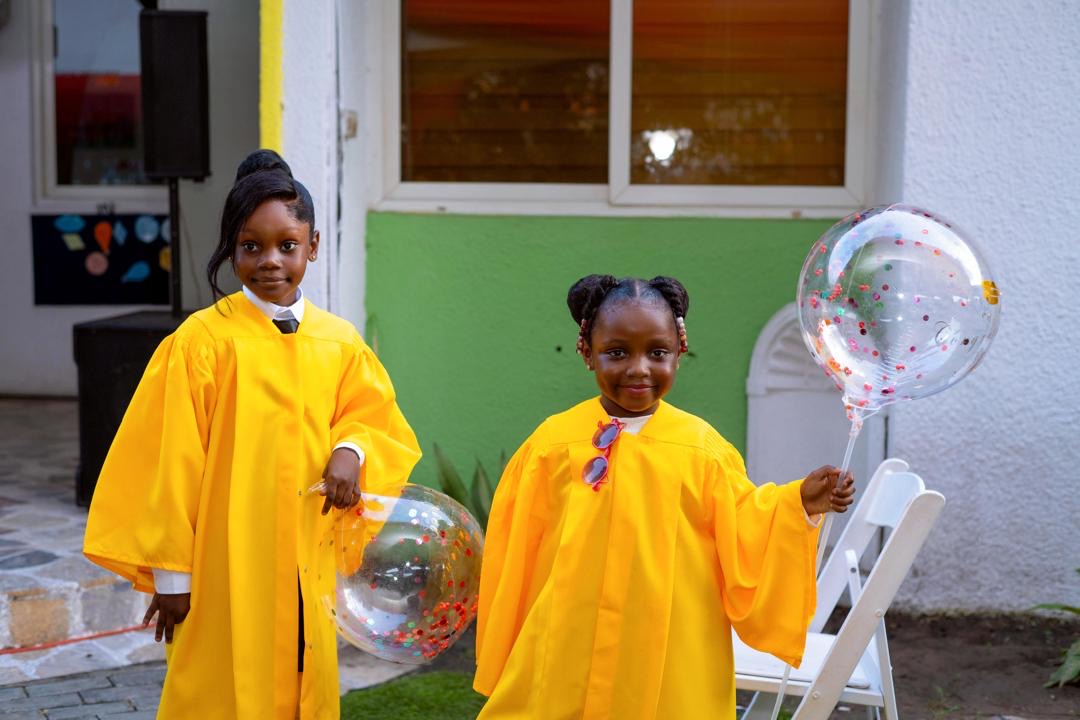 End of Year Show — children in graduation gowns